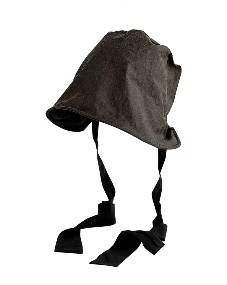 Xiangyunsha hat worn outdoors against stone wall
