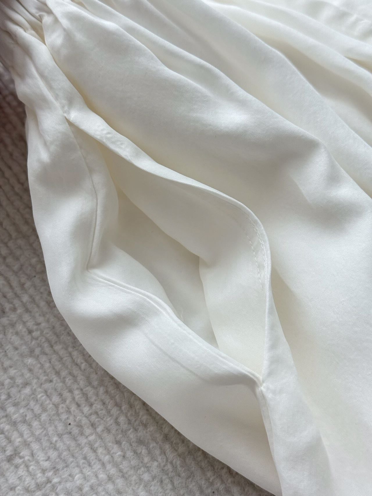 Cowl Neck Halter & Bubble Skirt Set · White — bubble hem fabric close-up showing drape and sheen